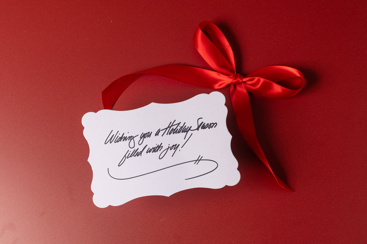 Handwritten gift message card on a Sweet Amelia's toffee box